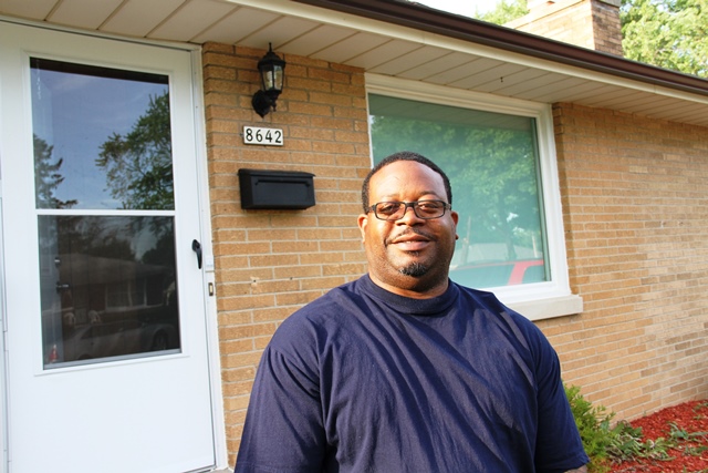 John Barbosa in front of his new home